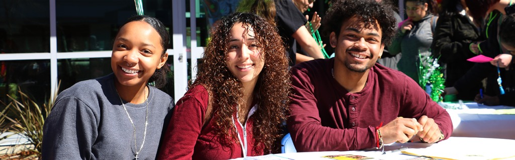 3 students smiling