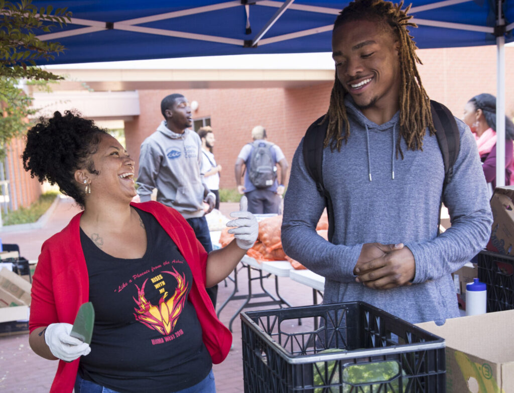 Two helpers at weekly food distribution