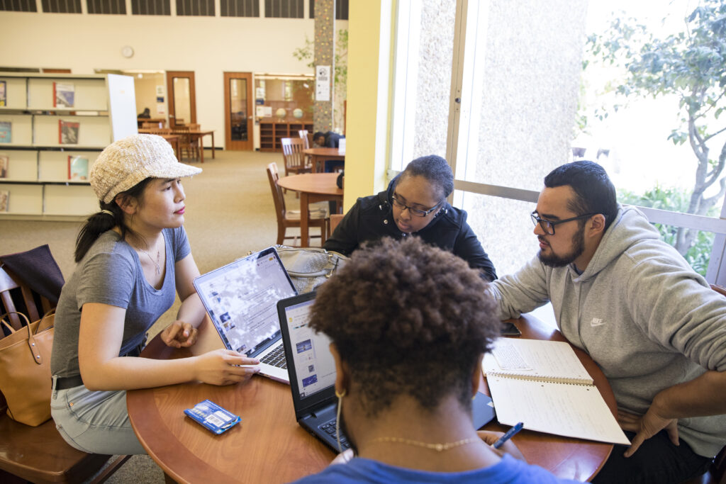 Students sitting at a table in the library