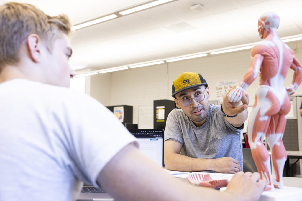 Two students at the tutoring center studying anatomy