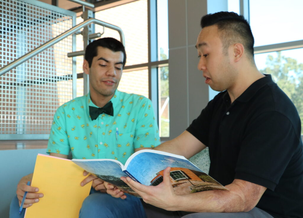 Two students sitting at a staircase